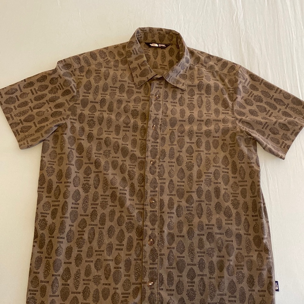 The North Face shortsleeved, button down shirt in a pine cone pattern.
